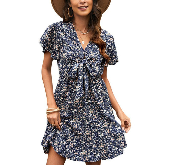 Elegant V-neck Dress with Floral Print and Lace-up Detailing.